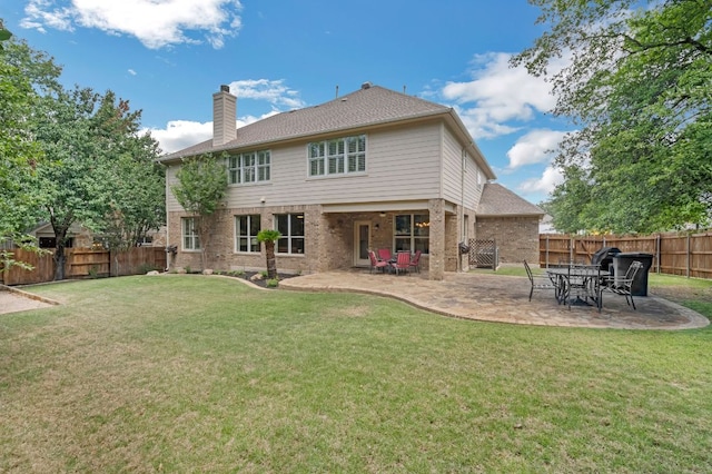 12709 Pinto Chase Ct, Austin, TX 78732 - rear view of house featuring a chimney, brick siding, and a patio