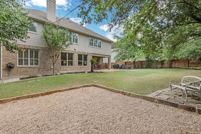 12709 Pinto Chase Ct, Austin, TX 78732 - back of house featuring a chimney, a patio area, and brick siding