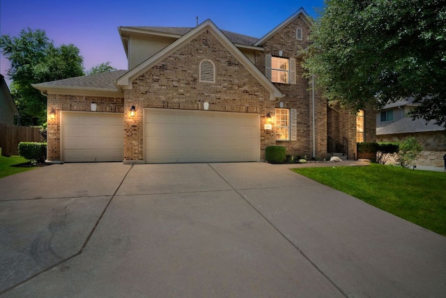 12709 Pinto Chase Ct, Austin, TX 78732 - view of front facade with driveway, brick siding, and a garage