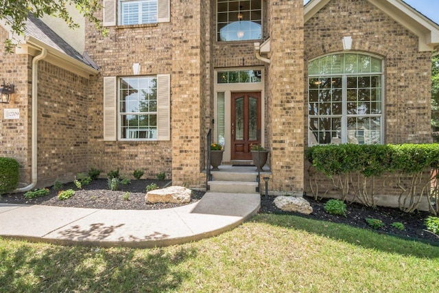 12709 Pinto Chase Ct, Austin, TX 78732 - entrance to property featuring brick siding, french doors, and a lawn