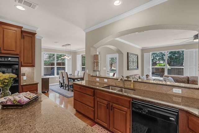 12709 Pinto Chase Ct, Austin, TX 78732 - kitchen with black appliances, a sink, ornamental molding, brown cabinetry, and light wood finished floors