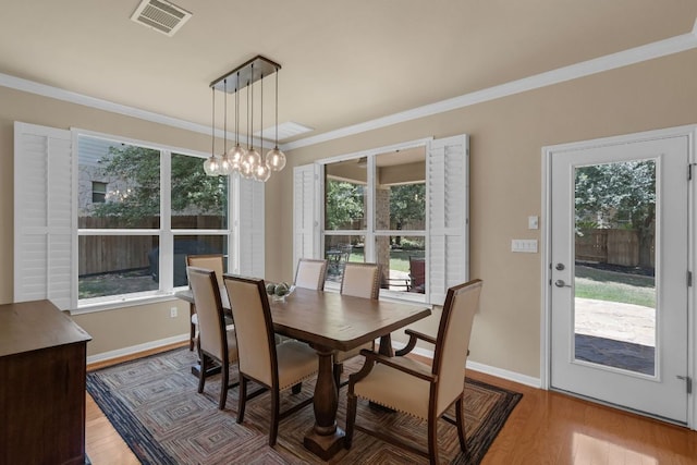 12709 Pinto Chase Ct, Austin, TX 78732 - dining space with plenty of natural light, wood finished floors, ornamental molding, and a chandelier