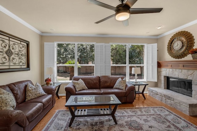 12709 Pinto Chase Ct, Austin, TX 78732 - living room with a fireplace, light wood-style flooring, a ceiling fan, and crown molding
