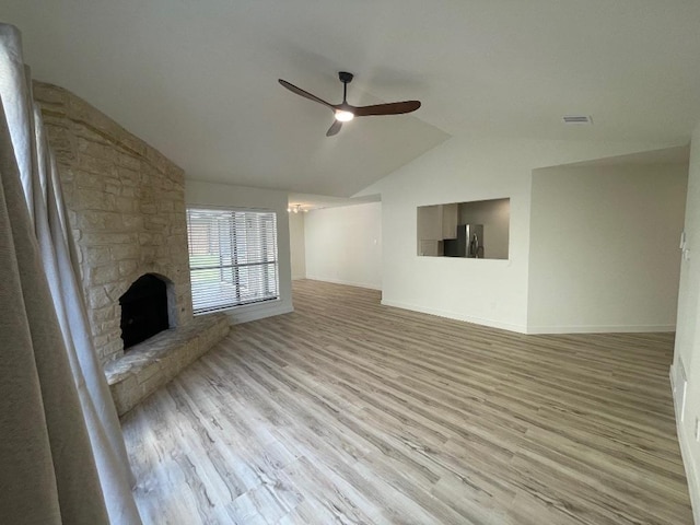 8527 Birmingham Dr, Austin, TX 78748 - unfurnished living room featuring a ceiling fan, lofted ceiling, wood finished floors, and a stone fireplace