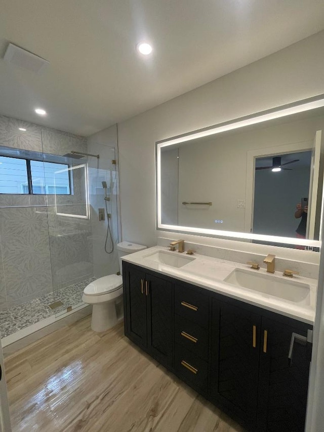 8527 Birmingham Dr, Austin, TX 78748 - full bathroom featuring double vanity, a stall shower, wood finished floors, and recessed lighting