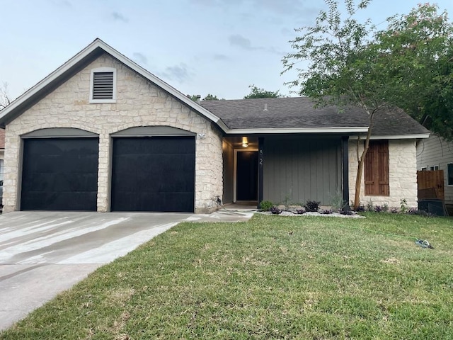 8527 Birmingham Dr, Austin, TX 78748 - view of front facade featuring driveway, a front lawn, an attached garage, and stone siding