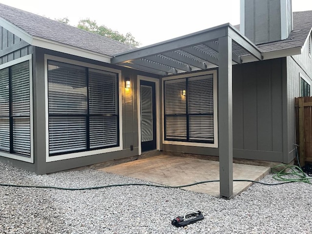 8527 Birmingham Dr, Austin, TX 78748 - view of exterior entry with a pergola, a shingled roof, and a patio area