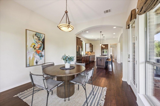 331 Littleton Dr, Austin, TX 78737 - dining space featuring arched walkways, dark wood-type flooring, and recessed lighting
