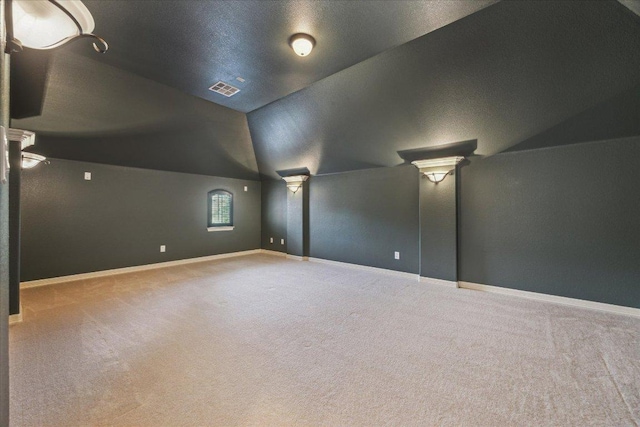 331 Littleton Dr, Austin, TX 78737 - additional living space with vaulted ceiling, carpet flooring, ornate columns, and baseboards