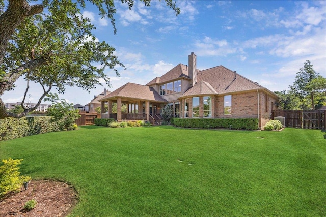 331 Littleton Dr, Austin, TX 78737 - rear view of house featuring a fenced backyard, a gazebo, a chimney, and brick siding