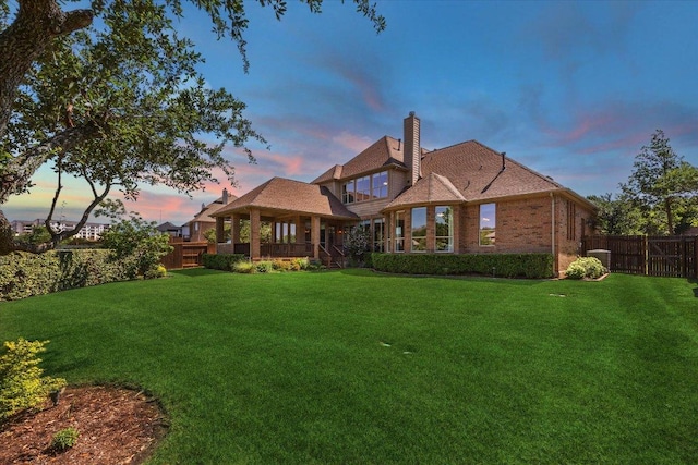 331 Littleton Dr, Austin, TX 78737 - back of property at dusk featuring a gazebo, a chimney, and brick siding