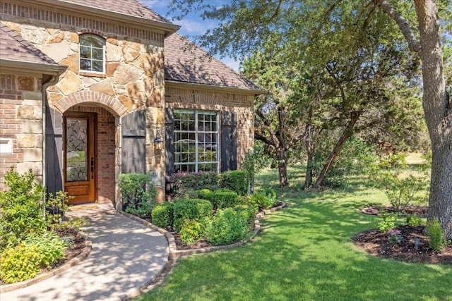 331 Littleton Dr, Austin, TX 78737 - entrance to property with stone siding, a lawn, a shingled roof, and brick siding