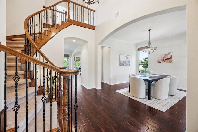 331 Littleton Dr, Austin, TX 78737 - foyer entrance featuring a chandelier, arched walkways, plenty of natural light, and hardwood / wood-style floors