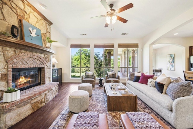 331 Littleton Dr, Austin, TX 78737 - living area with a ceiling fan, wood-type flooring, arched walkways, a brick fireplace, and baseboards