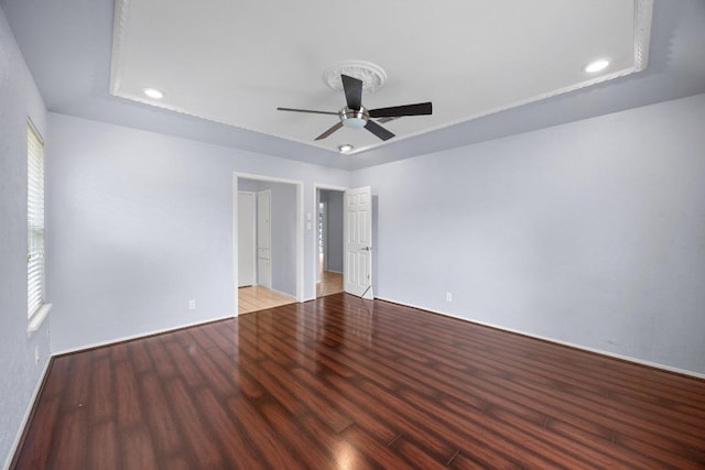 1301 S Meadows Dr, Austin, TX 78758 - unfurnished bedroom featuring wood finished floors, recessed lighting, a tray ceiling, and a ceiling fan
