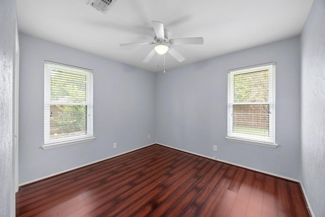 1301 S Meadows Dr, Austin, TX 78758 - unfurnished room with healthy amount of natural light, dark wood-style floors, and a ceiling fan