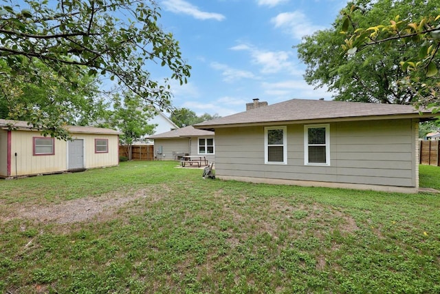 1301 S Meadows Dr, Austin, TX 78758 - rear view of house featuring a chimney and an outdoor structure