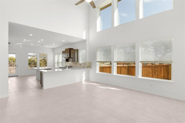 2705 Sage Ranch Dr Unit 20, Leander, TX 78641 - unfurnished living room featuring a ceiling fan, recessed lighting, and a towering ceiling