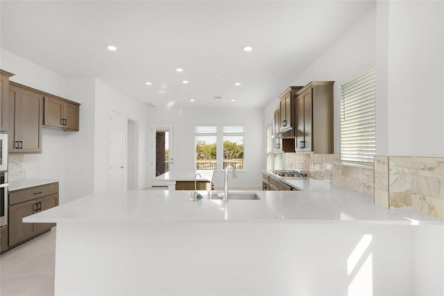 2705 Sage Ranch Dr Unit 20, Leander, TX 78641 - kitchen featuring a peninsula, light countertops, recessed lighting, stainless steel appliances, and tasteful backsplash