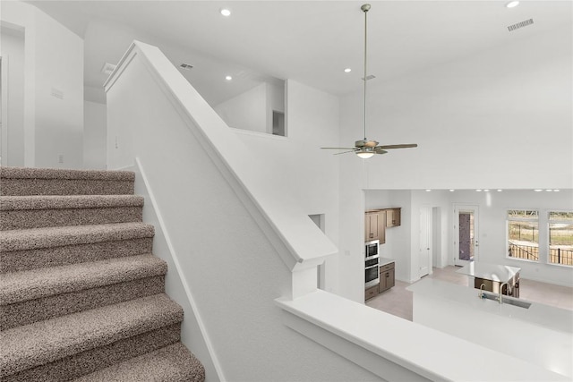 2705 Sage Ranch Dr Unit 20, Leander, TX 78641 - stairs with recessed lighting, a ceiling fan, and a towering ceiling