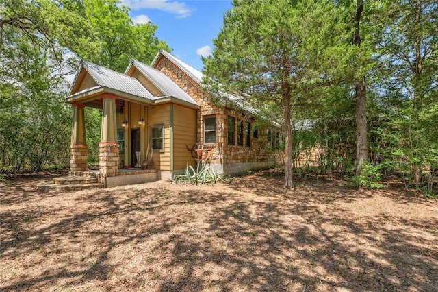 136 Red Fox Ln, Bastrop, TX 78602 - view of front facade featuring covered porch and metal roof