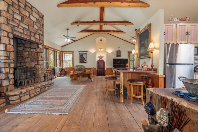 136 Red Fox Ln, Bastrop, TX 78602 - living room featuring a ceiling fan, a wood stove, and hardwood / wood-style floors