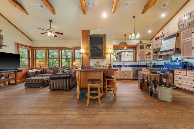 136 Red Fox Ln, Bastrop, TX 78602 - kitchen with beam ceiling, premium range hood, hardwood / wood-style floors, a ceiling fan, and open floor plan