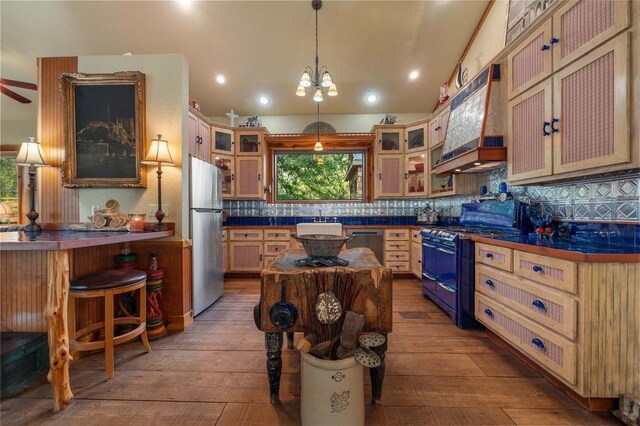 136 Red Fox Ln, Bastrop, TX 78602 - kitchen with stainless steel appliances, hardwood / wood-style flooring, dark countertops, and recessed lighting