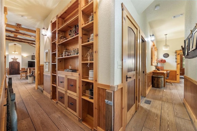 136 Red Fox Ln, Bastrop, TX 78602 - hall featuring light wood-style floors, beam ceiling, and wainscoting