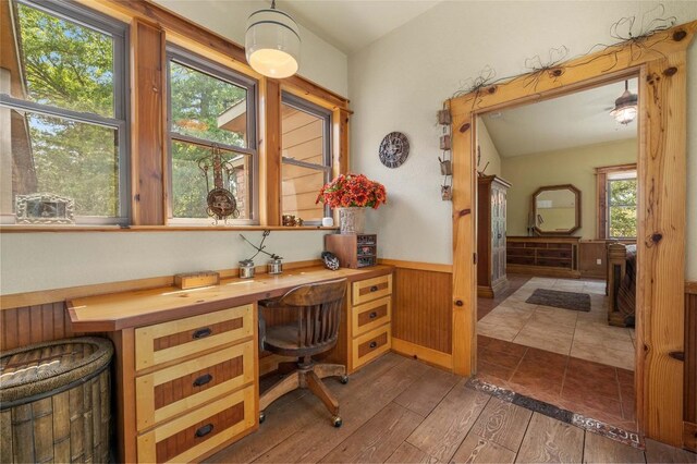 136 Red Fox Ln, Bastrop, TX 78602 - office area with wainscoting, hardwood / wood-style floors, built in study area, and wood walls