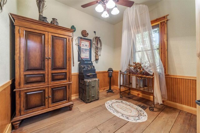 136 Red Fox Ln, Bastrop, TX 78602 - entrance foyer featuring wainscoting, light wood finished floors, ceiling fan, and wood walls