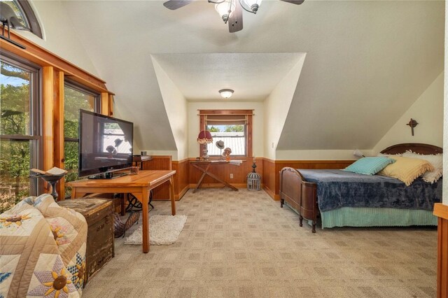 136 Red Fox Ln, Bastrop, TX 78602 - bedroom featuring light carpet, wainscoting, vaulted ceiling, and wood walls