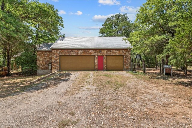 136 Red Fox Ln, Bastrop, TX 78602 - garage featuring dirt driveway