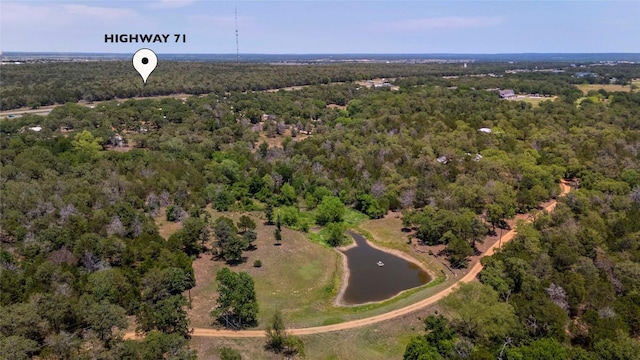 136 Red Fox Ln, Bastrop, TX 78602 - aerial view of property and surrounding area featuring a heavily wooded area