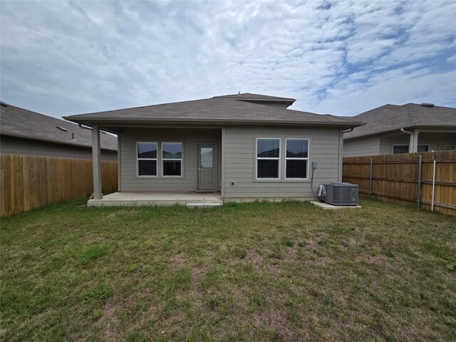 12324 Token Trl, Elgin, TX 78621 - rear view of house with a patio area and central AC unit