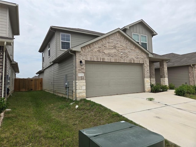 12324 Token Trl, Elgin, TX 78621 - view of front of house with stone siding, concrete driveway, board and batten siding, and a garage