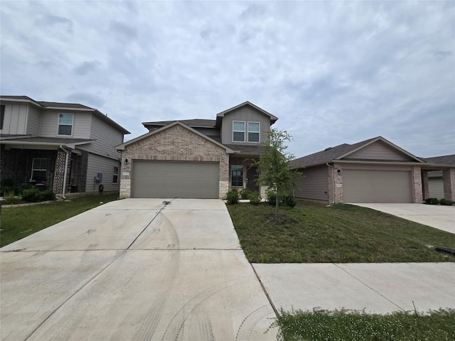 12324 Token Trl, Elgin, TX 78621 - view of front of home featuring driveway, a garage, a front lawn, and stone siding