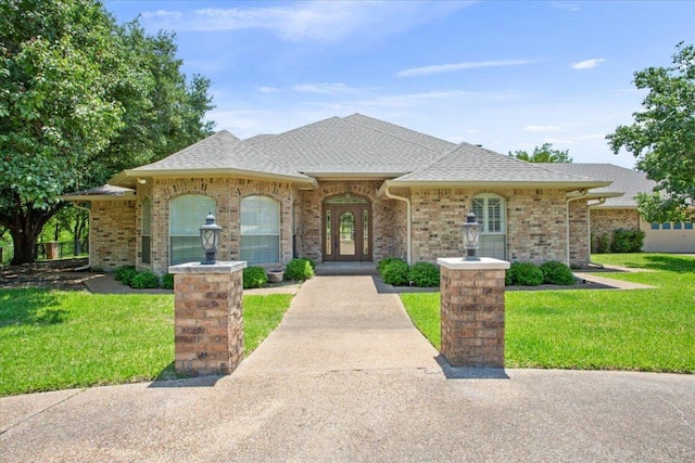 1204 Fairway Cir, Salado, TX 76571 - view of front of home with a front yard, brick siding, and roof with shingles
