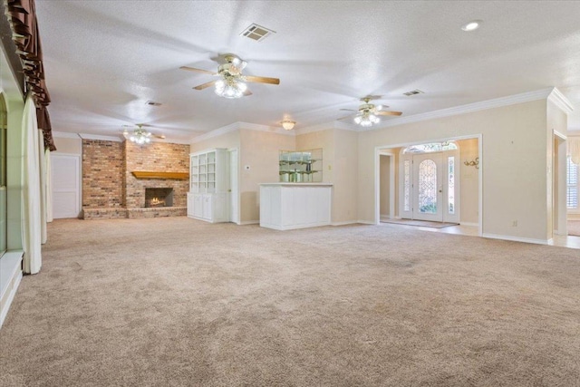 1204 Fairway Cir, Salado, TX 76571 - unfurnished living room featuring ceiling fan, carpet, crown molding, a fireplace, and a textured ceiling