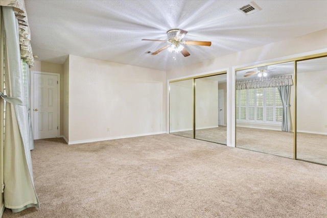 1204 Fairway Cir, Salado, TX 76571 - unfurnished bedroom featuring two closets, carpet floors, and a ceiling fan