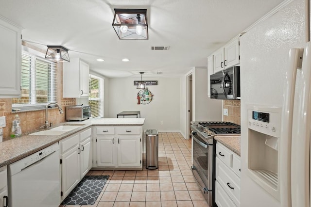 12508 Terra Nova Ln, Austin, TX 78727 - kitchen with stainless steel appliances, a sink, tasteful backsplash, light countertops, and white cabinets