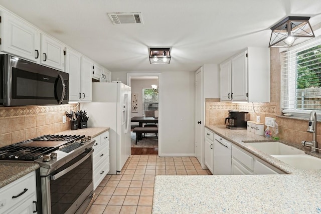 12508 Terra Nova Ln, Austin, TX 78727 - kitchen featuring white appliances, a sink, light tile patterned flooring, and white cabinets