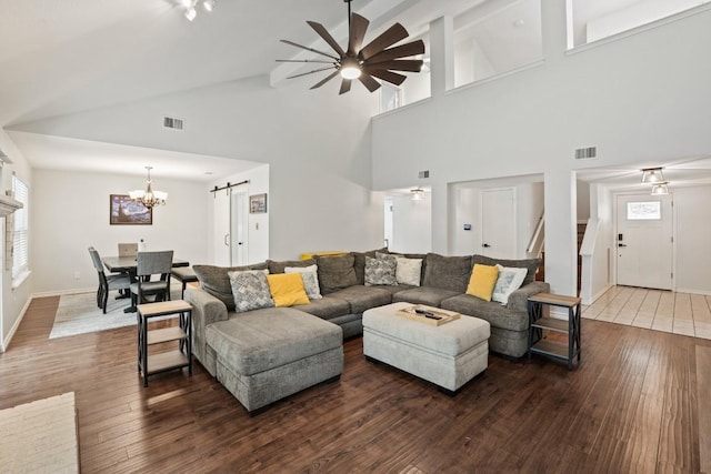 12508 Terra Nova Ln, Austin, TX 78727 - living area with wood-type flooring, a chandelier, a ceiling fan, a barn door, and plenty of natural light