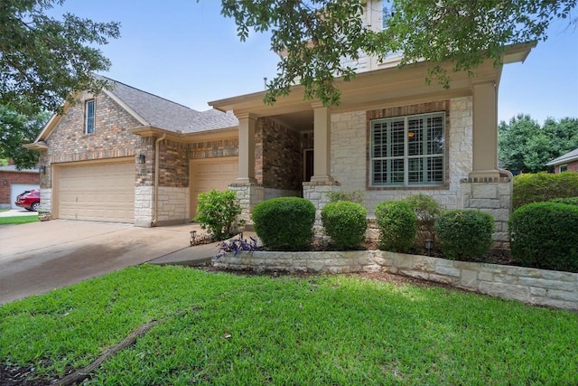 306 Water Oak Dr, Cedar Park, TX 78613 - view of front of home featuring a garage, driveway, a front lawn, stone siding, and brick siding
