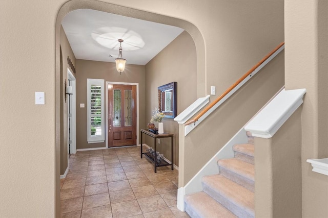 306 Water Oak Dr, Cedar Park, TX 78613 - foyer with arched walkways, stairs, baseboards, and light tile patterned floors
