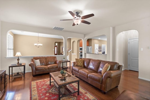 306 Water Oak Dr, Cedar Park, TX 78613 - living area featuring arched walkways, wood finished floors, a ceiling fan, and a chandelier