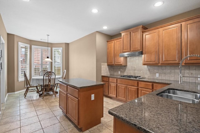306 Water Oak Dr, Cedar Park, TX 78613 - kitchen featuring a sink, under cabinet range hood, decorative backsplash, brown cabinetry, and recessed lighting