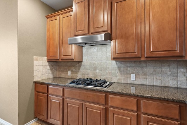 306 Water Oak Dr, Cedar Park, TX 78613 - kitchen with black gas stovetop, exhaust hood, tasteful backsplash, baseboards, and brown cabinetry