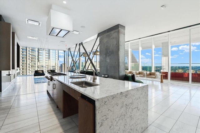 301 W Ave Unit 4103, Austin, TX 78701 - kitchen featuring open floor plan, expansive windows, a sink, modern cabinets, and light tile patterned flooring