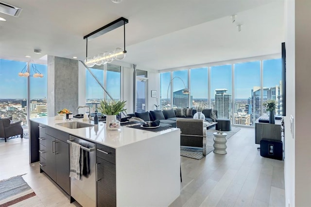 301 W Ave Unit 4103, Austin, TX 78701 - kitchen with a sink, expansive windows, stainless steel dishwasher, open floor plan, and a center island with sink